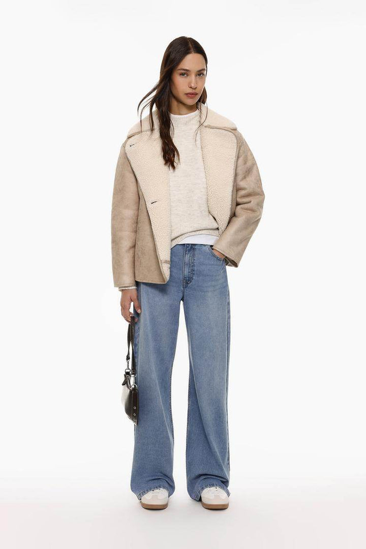 Full body front view of woman wearing beige brown double-faced coat

