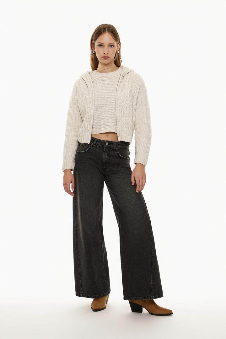 Full body front view of woman wearing beige chenille jacket

