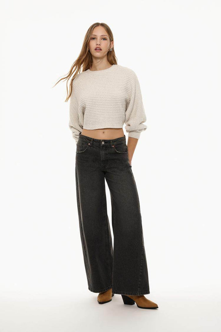 Full body front view of woman wearing beige cropped chenille sweater


