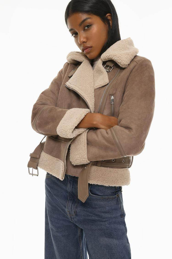 Close-up front view of beige crossover jacket details

