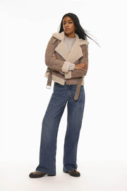 Full body front view of woman wearing beige double-faced crossover jacket

