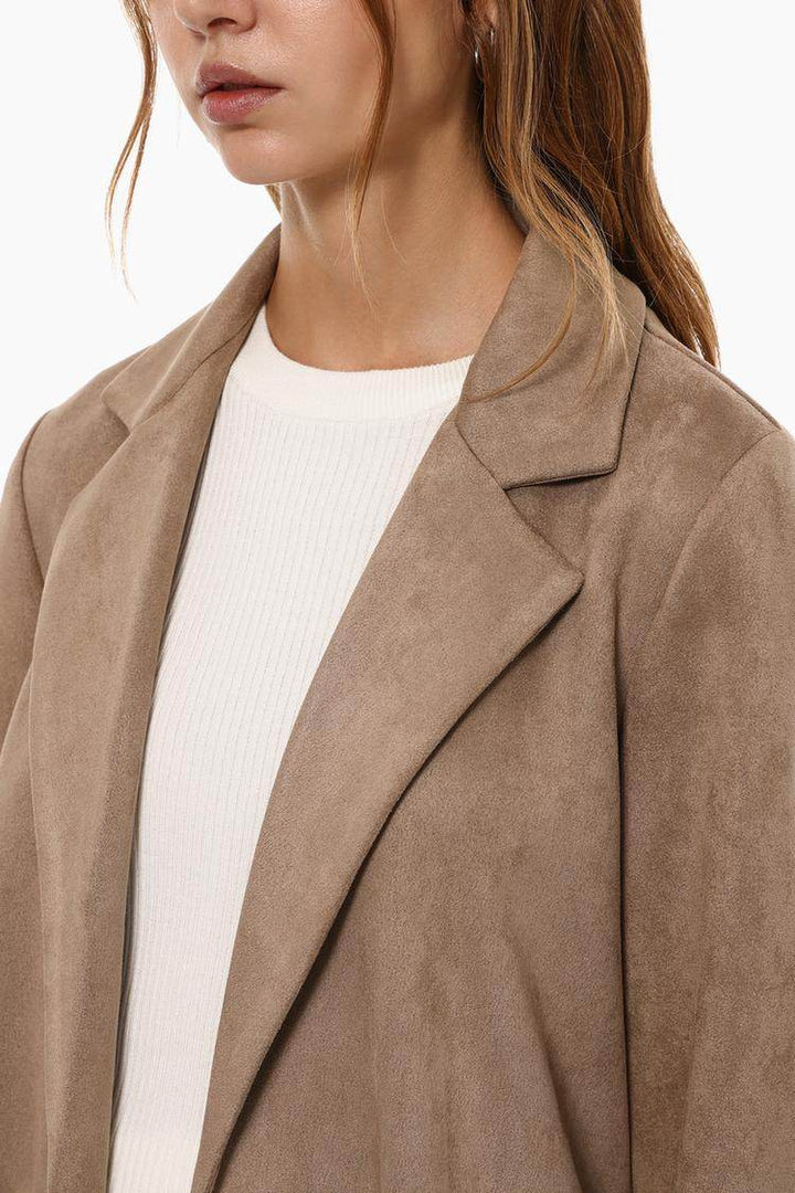 Close-up front view of beige faux suede coat

