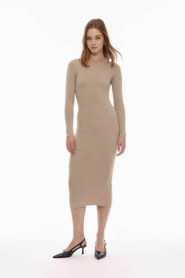 Full body front view of a woman wearing a beige knit midi dress

