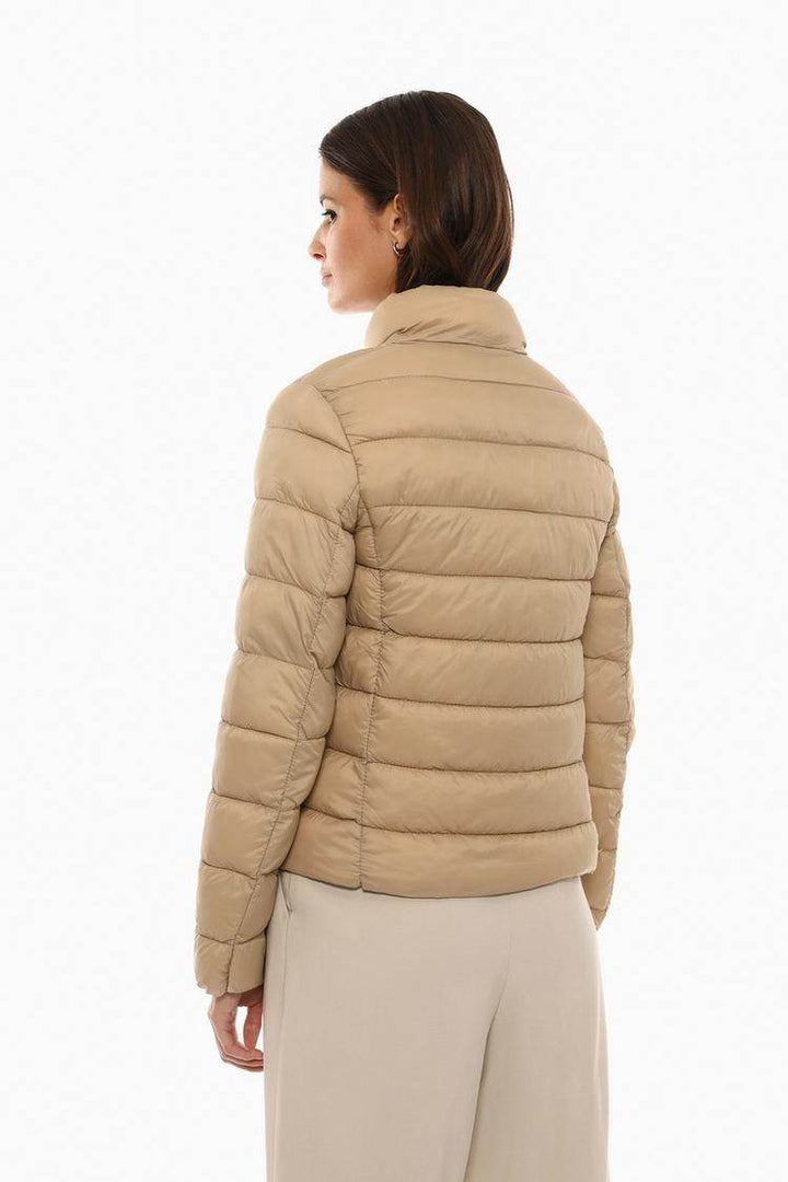 Back view of the women's beige lightweight puffer jacket

