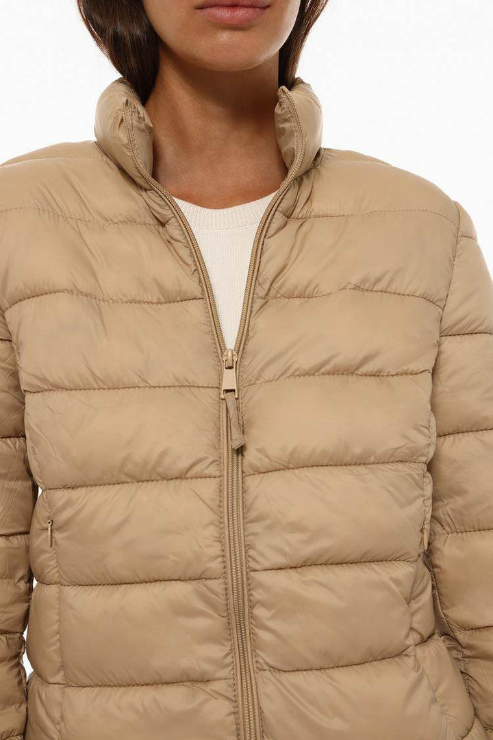 Close-up front view of beige lightweight puffer jacket

