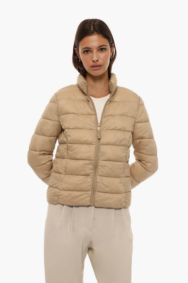 Front view of women's beige basic lightweight puffer jacket

