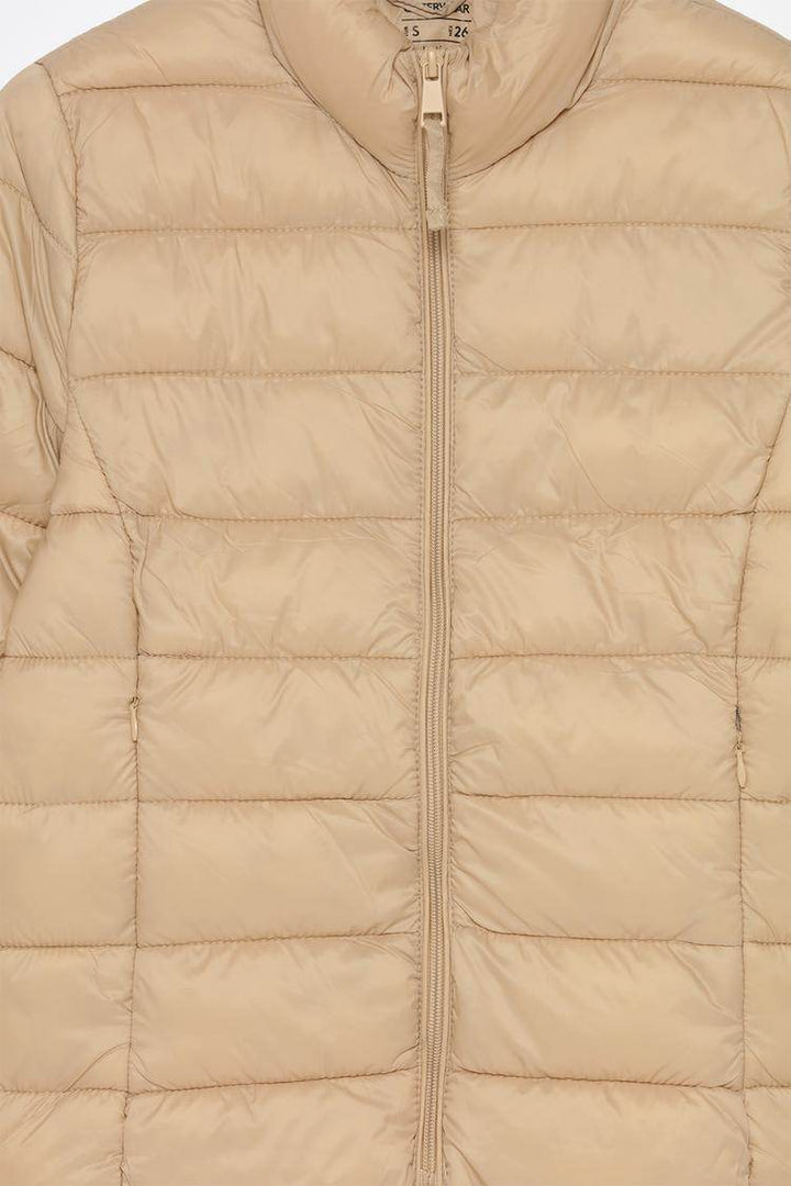 Close-up product image of beige puffer jacket

