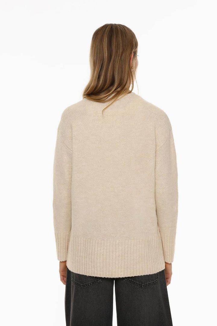 Back view of the women's beige long soft sweater

