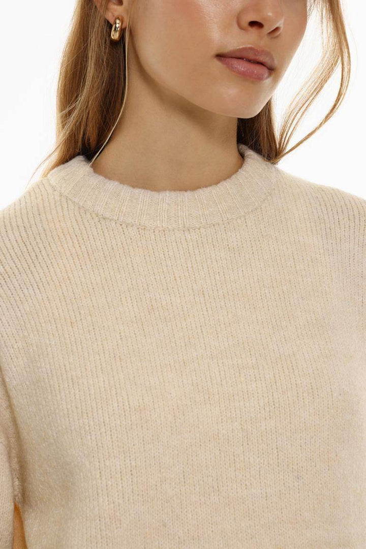 Close-up front view of beige soft sweater


