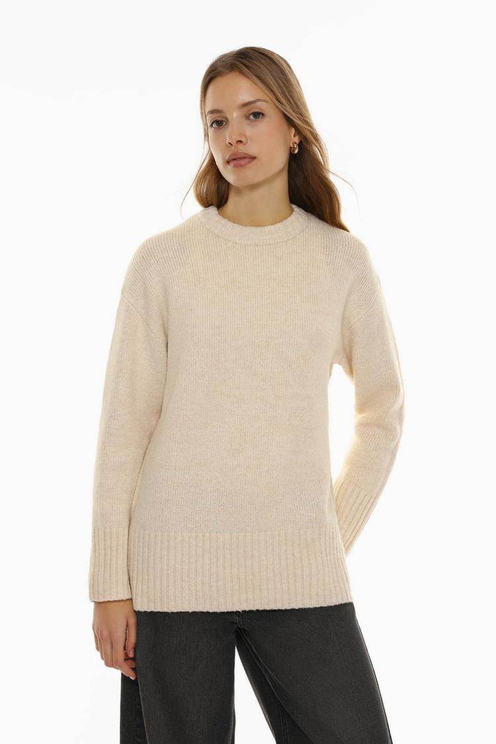 Front view of women's beige long soft sweater

