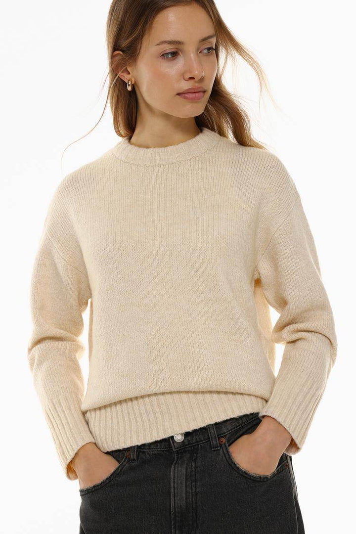 Model showcasing beige long soft sweater front

