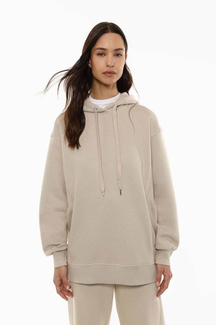 Front view of women's beige oversized plush sweatshirt

