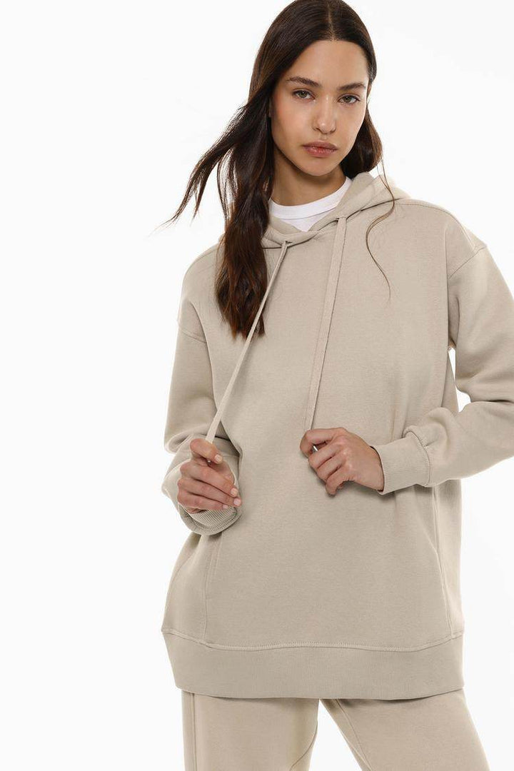 Model showcasing beige plush sweatshirt front

