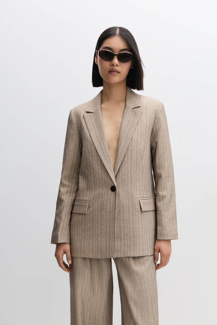 Front full body view of a beige women's pinstripe blazer
