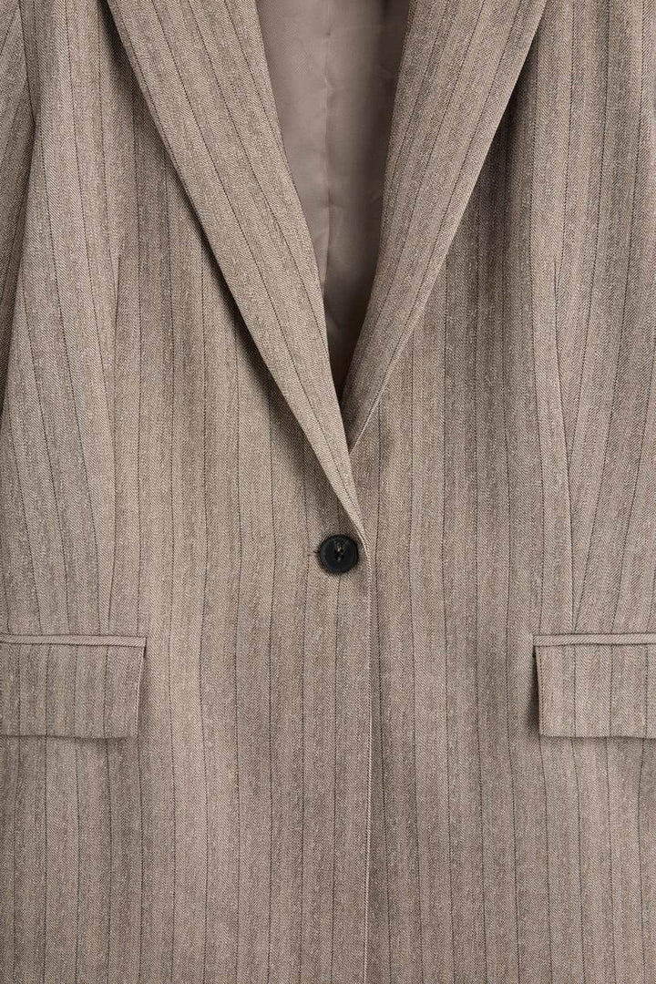 Zoomed view of a beige women's pinstripe blazer
