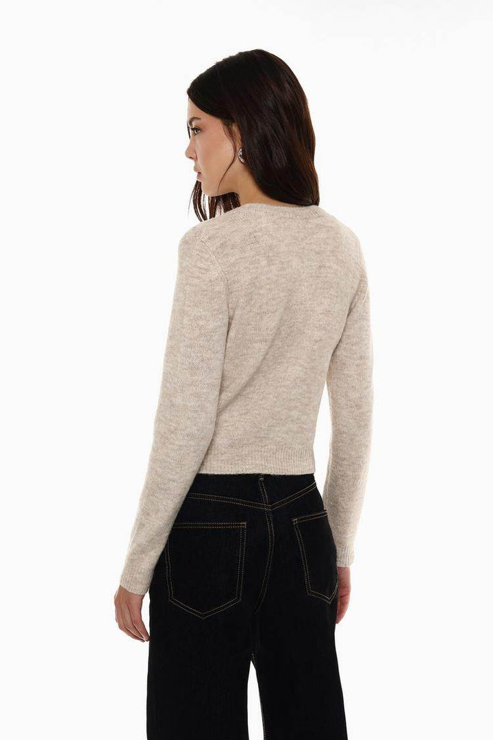 Back view of the women's beige rounded neck knit cardigan

