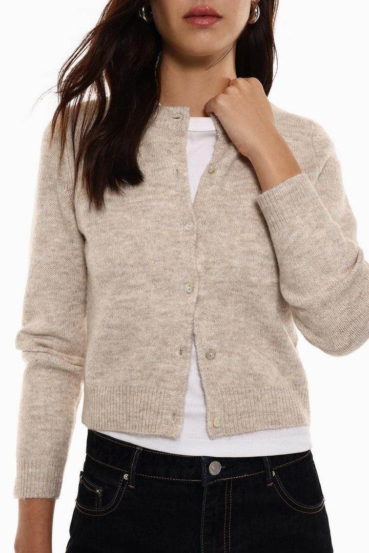 Close-up front view of beige knit cardigan

