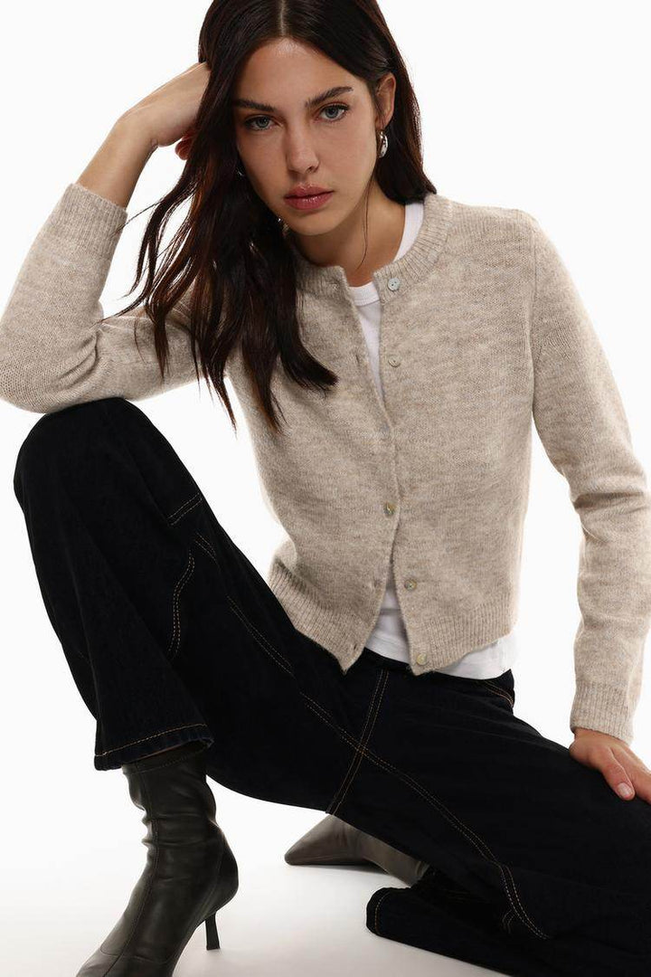 Model showcasing beige knit cardigan front

