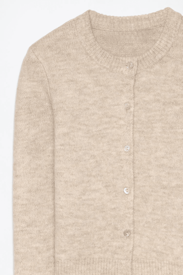 Close-up product image of beige knit cardigan

