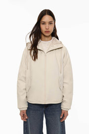 Front view of women's beige rubberised parka

