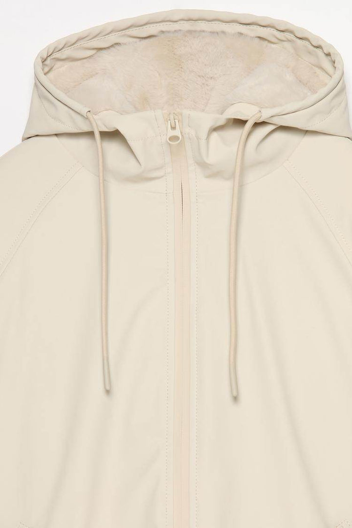 Close-up product image of beige rubberised parka

