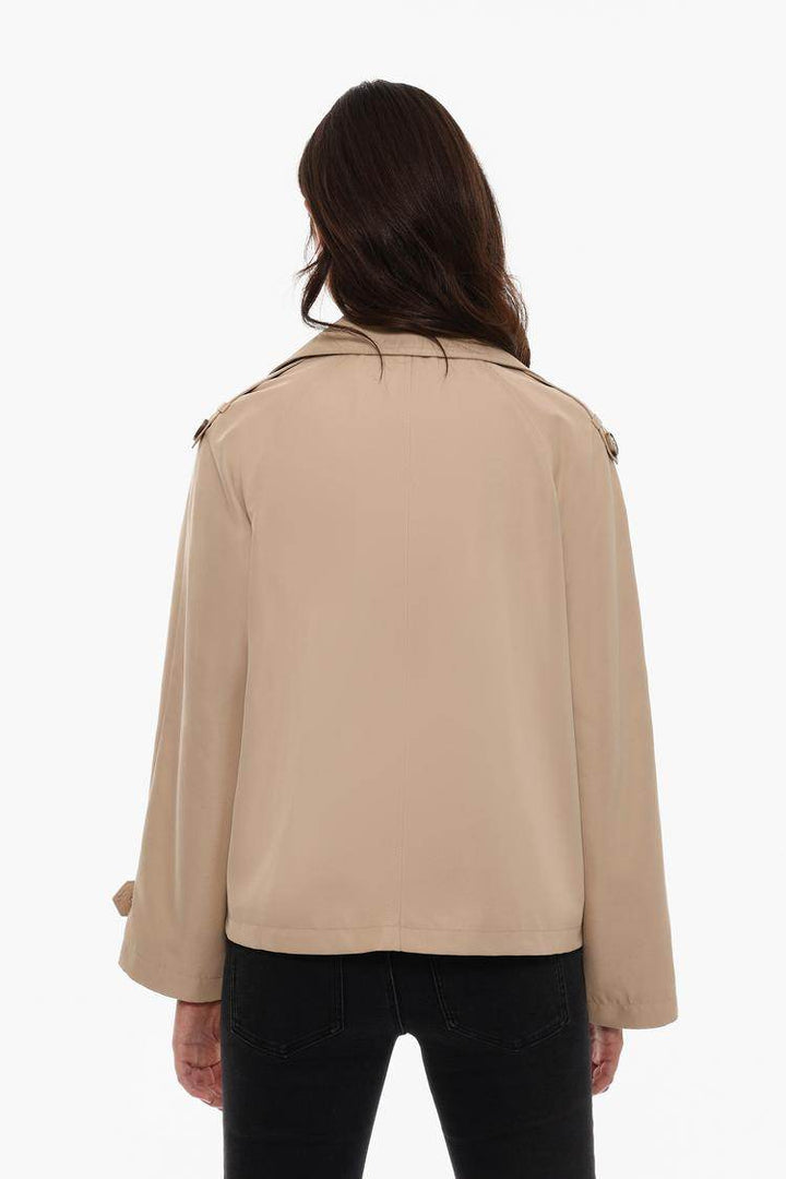 Back view of the women's beige short oversize trench coat

