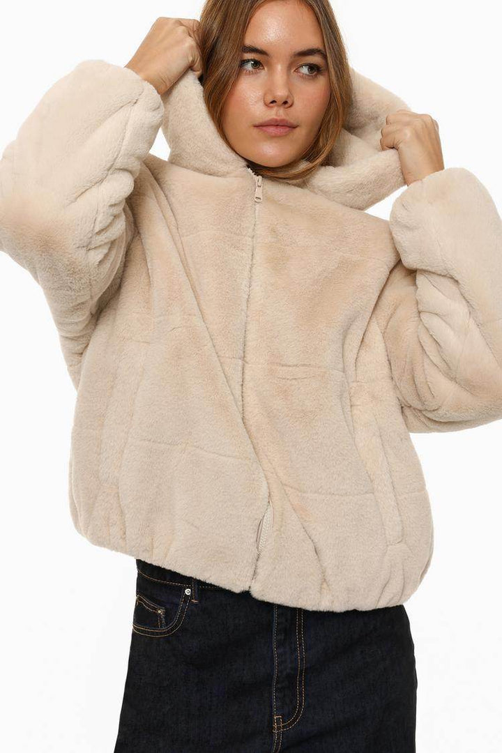 Close-up front view of beige short soft coat

