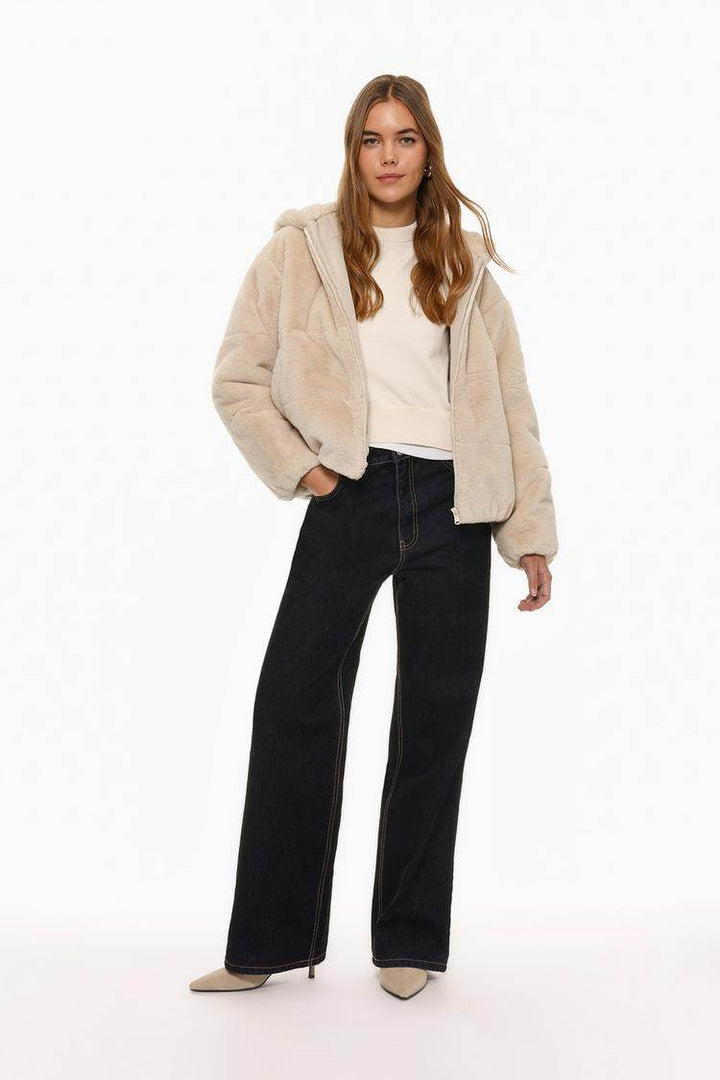 Full body front view of woman wearing beige short soft coat

