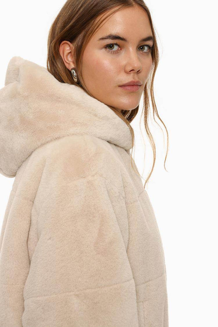 Side view of the women's beige short soft coat

