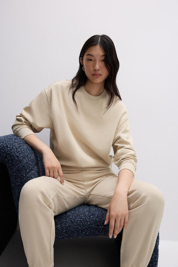 Front view of a beige women's sweatshirt