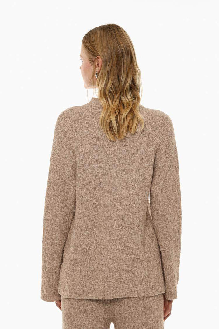 Back view of the women's beige textured knit sweater

