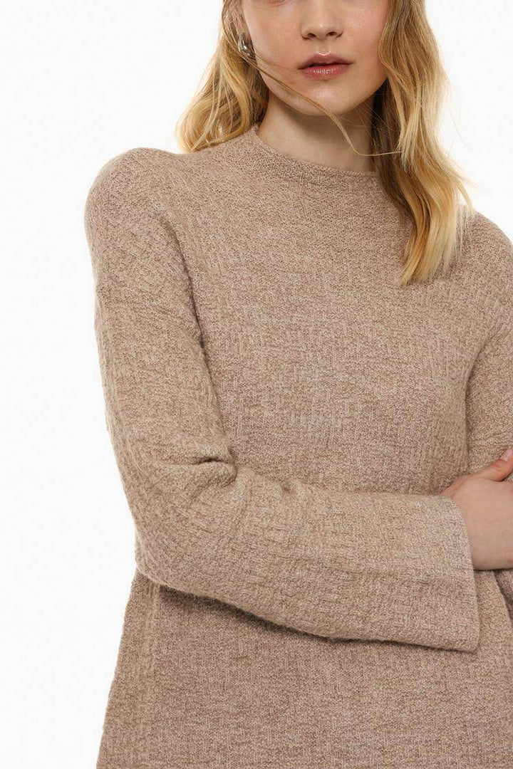 Close-up front view of beige textured knit

