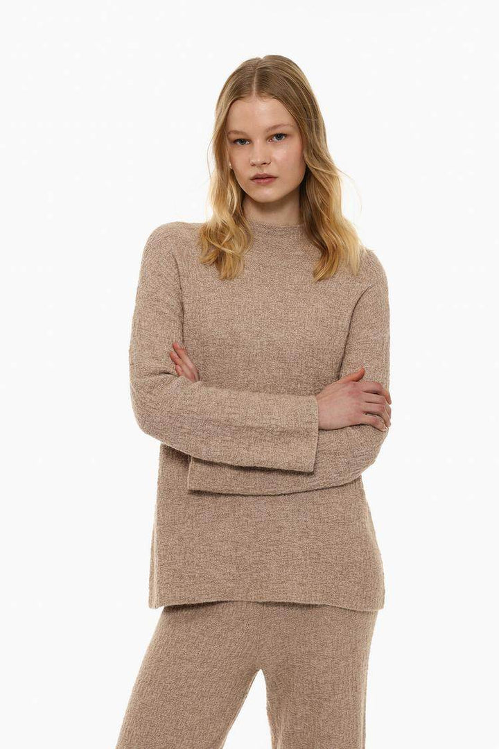 Front view of women's beige textured knit sweater

