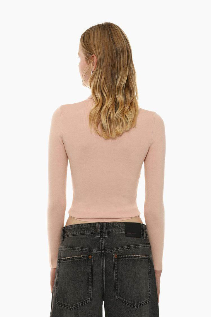 Back view of the women's beige turtleneck sweater

