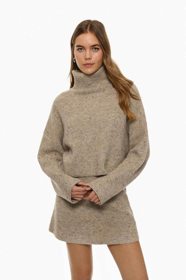 Front view of women's beige turtleneck sweater long sleeve

