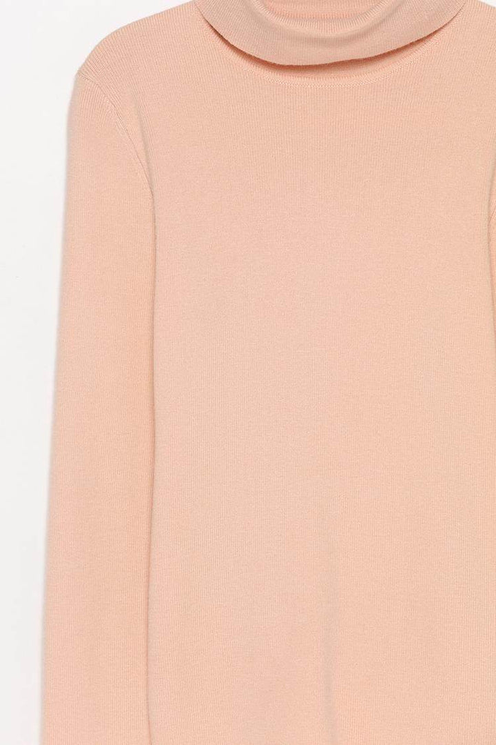 Close-up product image of beige turtleneck sweater fabric

