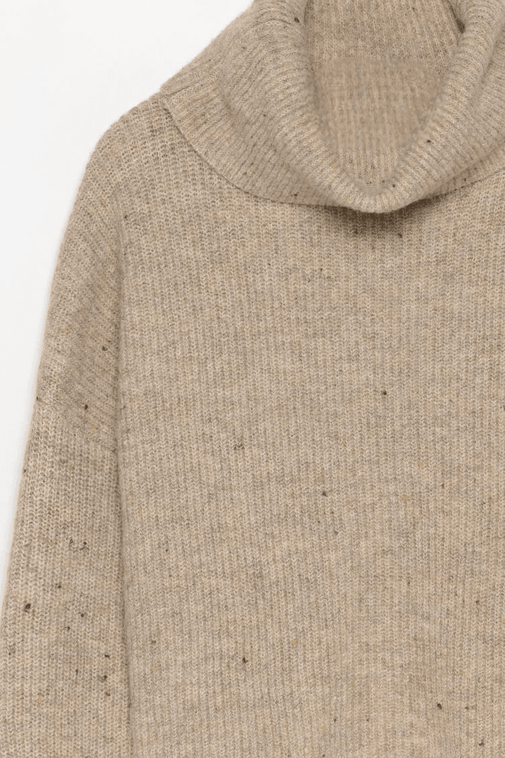 Close-up product image of beige turtleneck sweater

