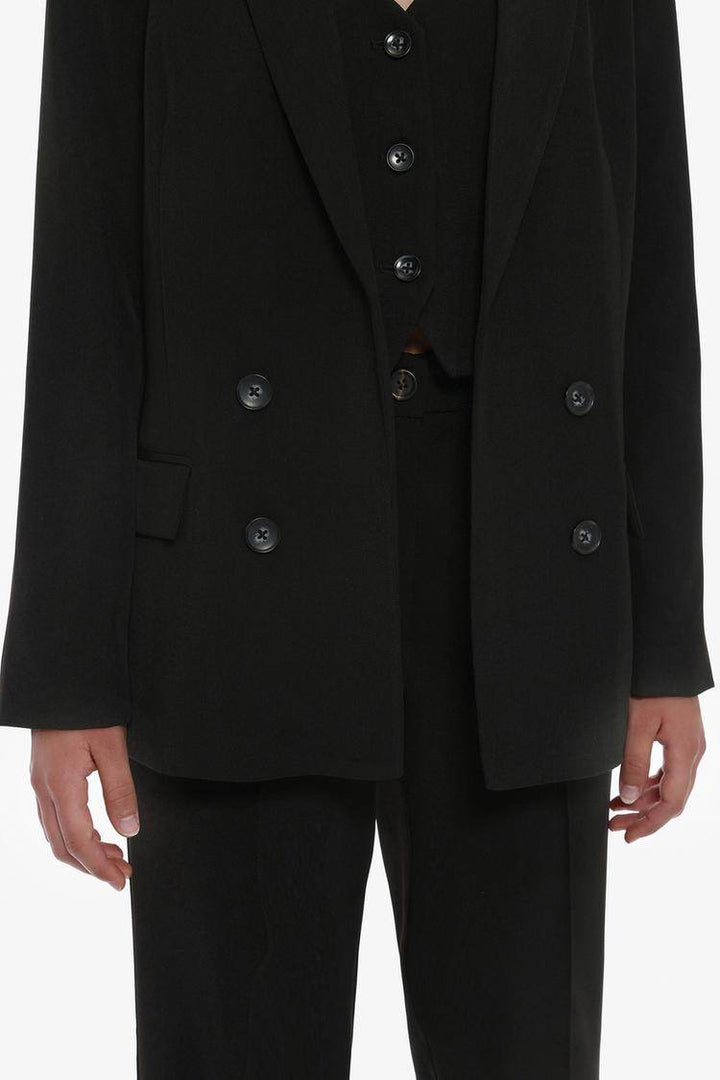 Model showcasing black basic blazer front view

