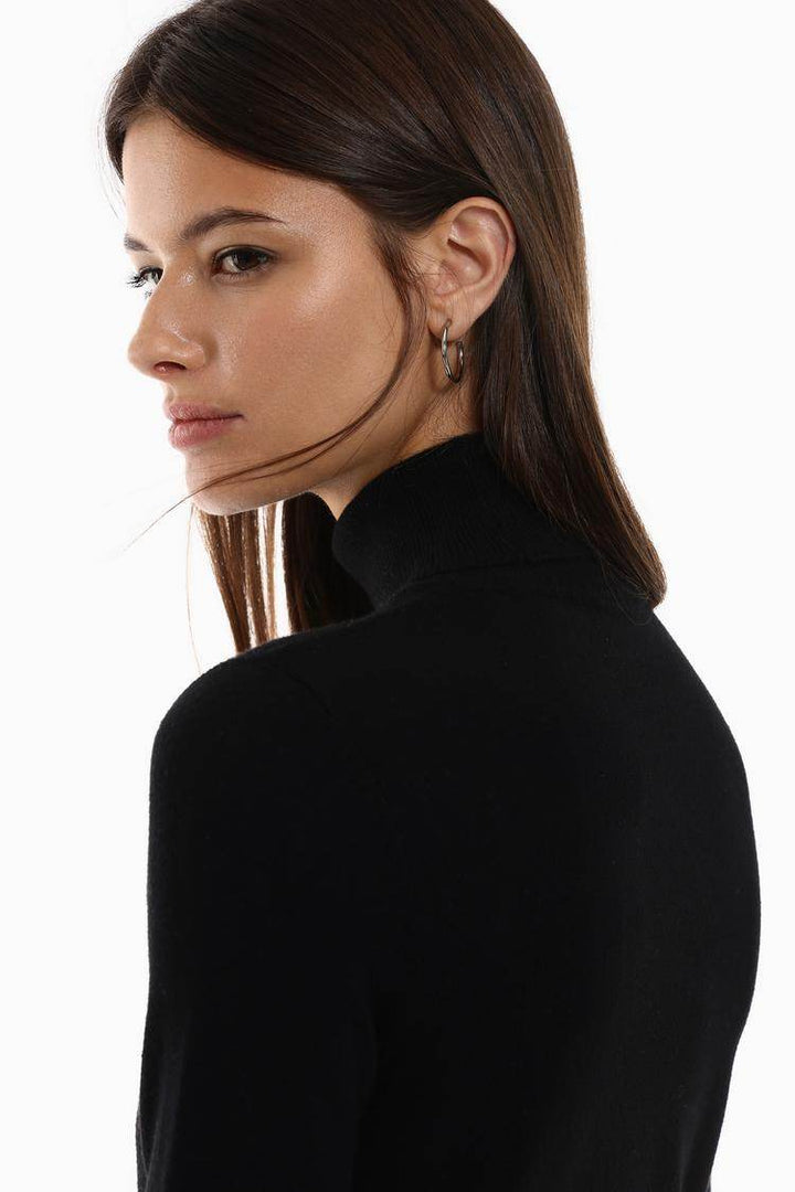 Side view of the women's black basic turtleneck sweater

