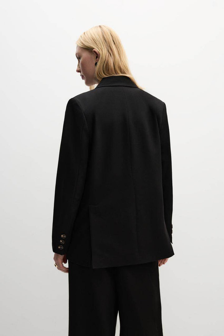 Back view of a black women's blazer
