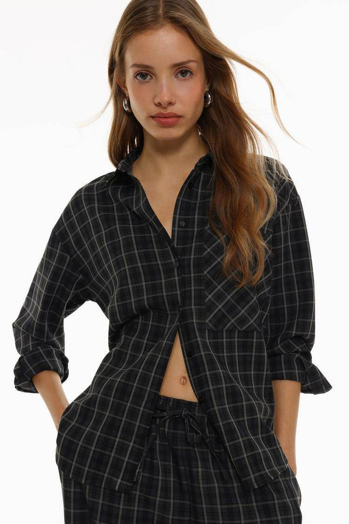 Model showcasing front of black checked shirt

