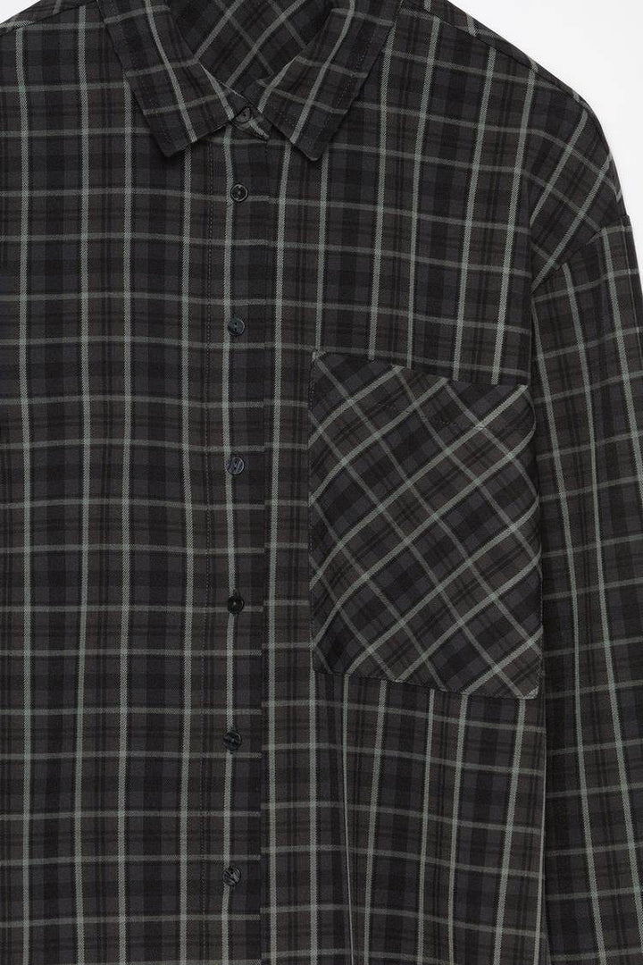 Close-up product image of black checked shirt

