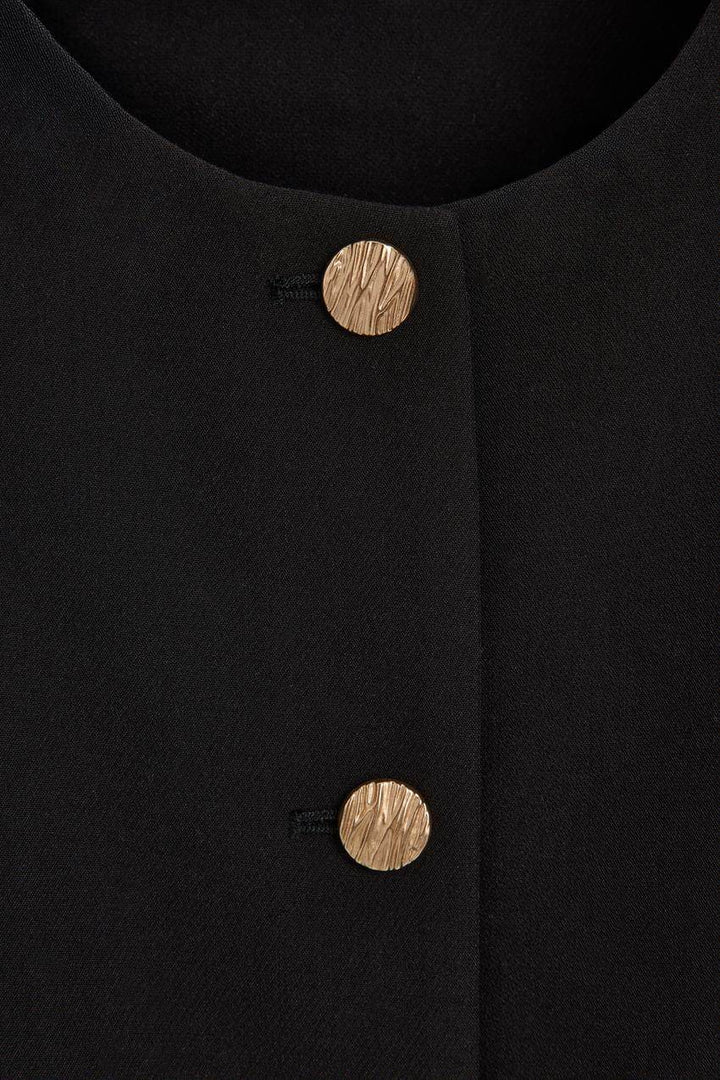 Front view showing the material of a black women's cropped blazer
