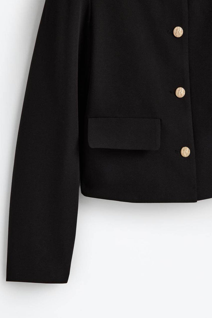 Zoomed front view of a black women's cropped blazer
