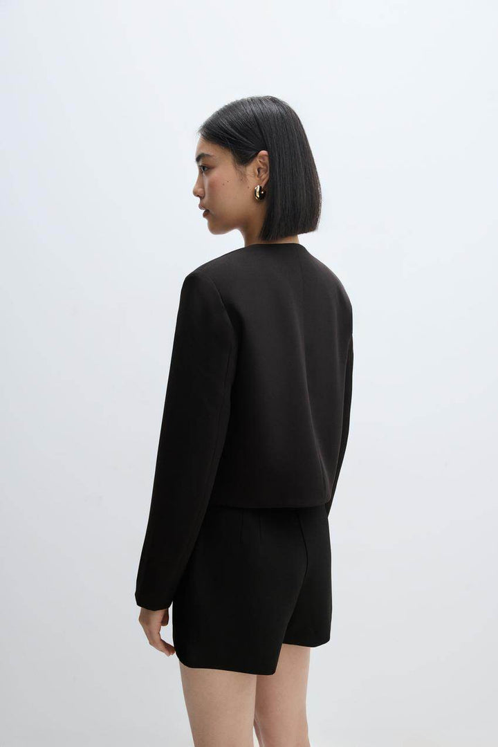 Side view of a black women's cropped blazer
