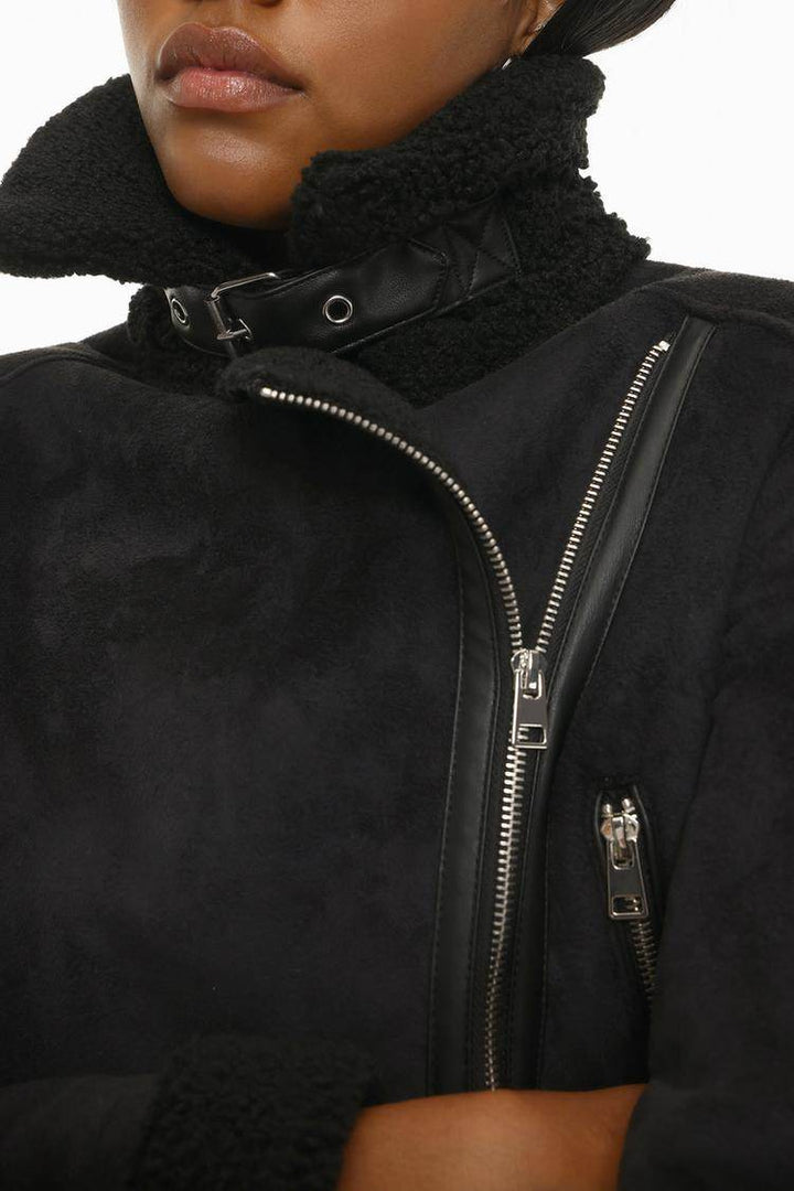 Close-up front view of black crossover jacket

