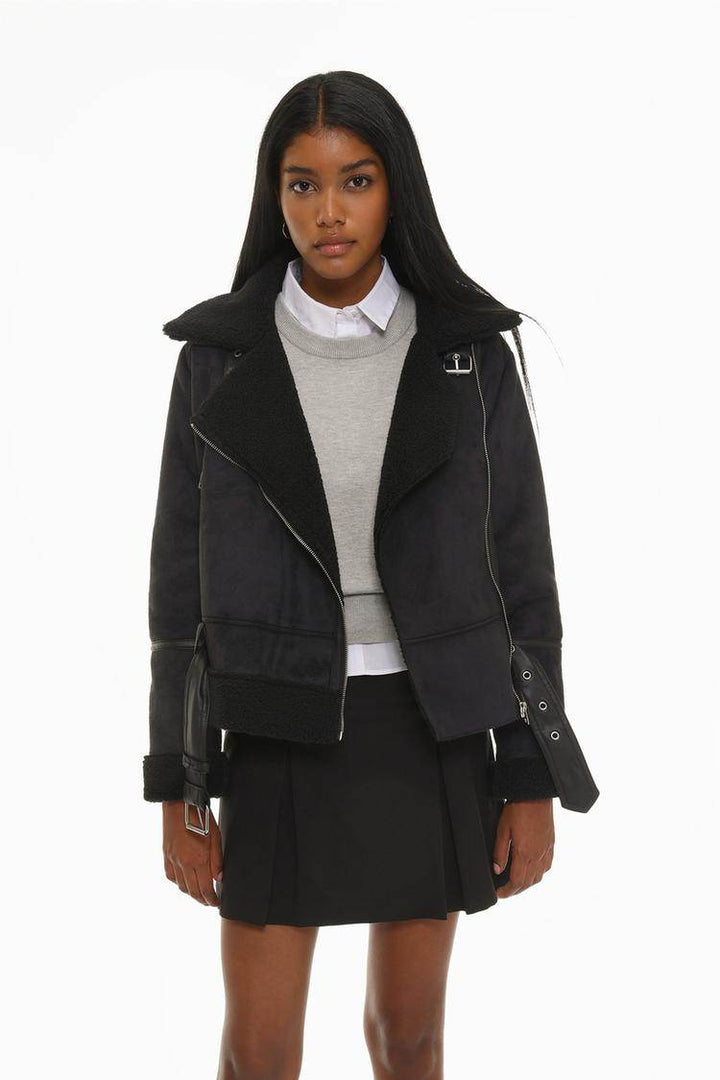 Model showcasing black double-faced crossover jacket front

