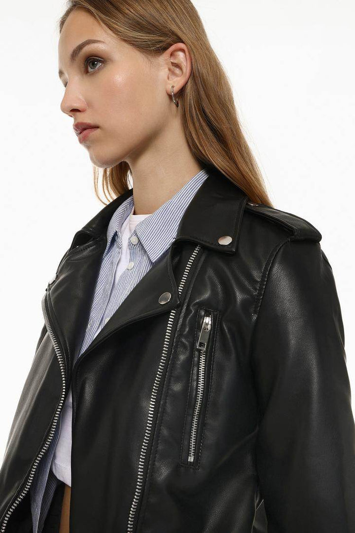 Side view of women's black faux leather crossover jacket

