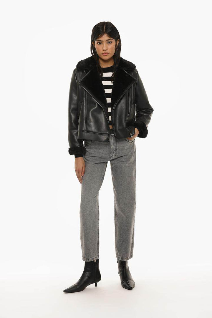 Full body front view of woman wearing faux leather jacket

