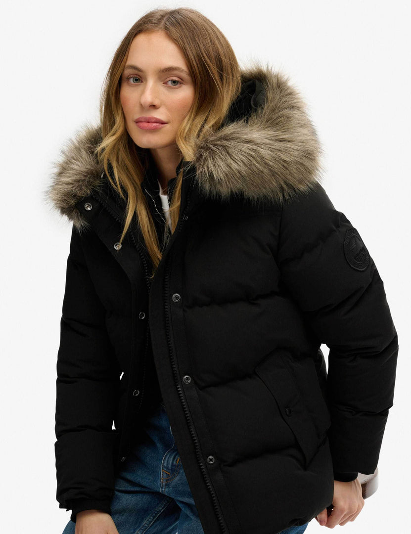 Side view of the black hooded funnel neck puffer jacket

